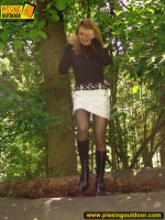 Teen blonde pisses on a log