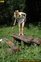 Pissing outdoor on a wooden table