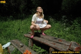 Pissing outdoor on a wooden table