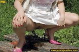 Pissing outdoor on a wooden table