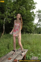 Girl pissing on wooden table