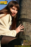 Pissing teen brunette licks her pee from a column