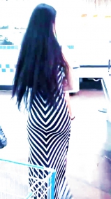 Sexy filipino babe in long striped skirt shopping for meat
