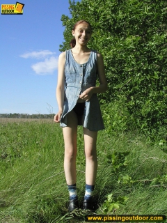 Pissing outdoor on a green grass - N