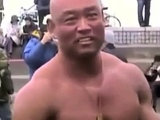 Asian bodybuilder barely covered at the beach